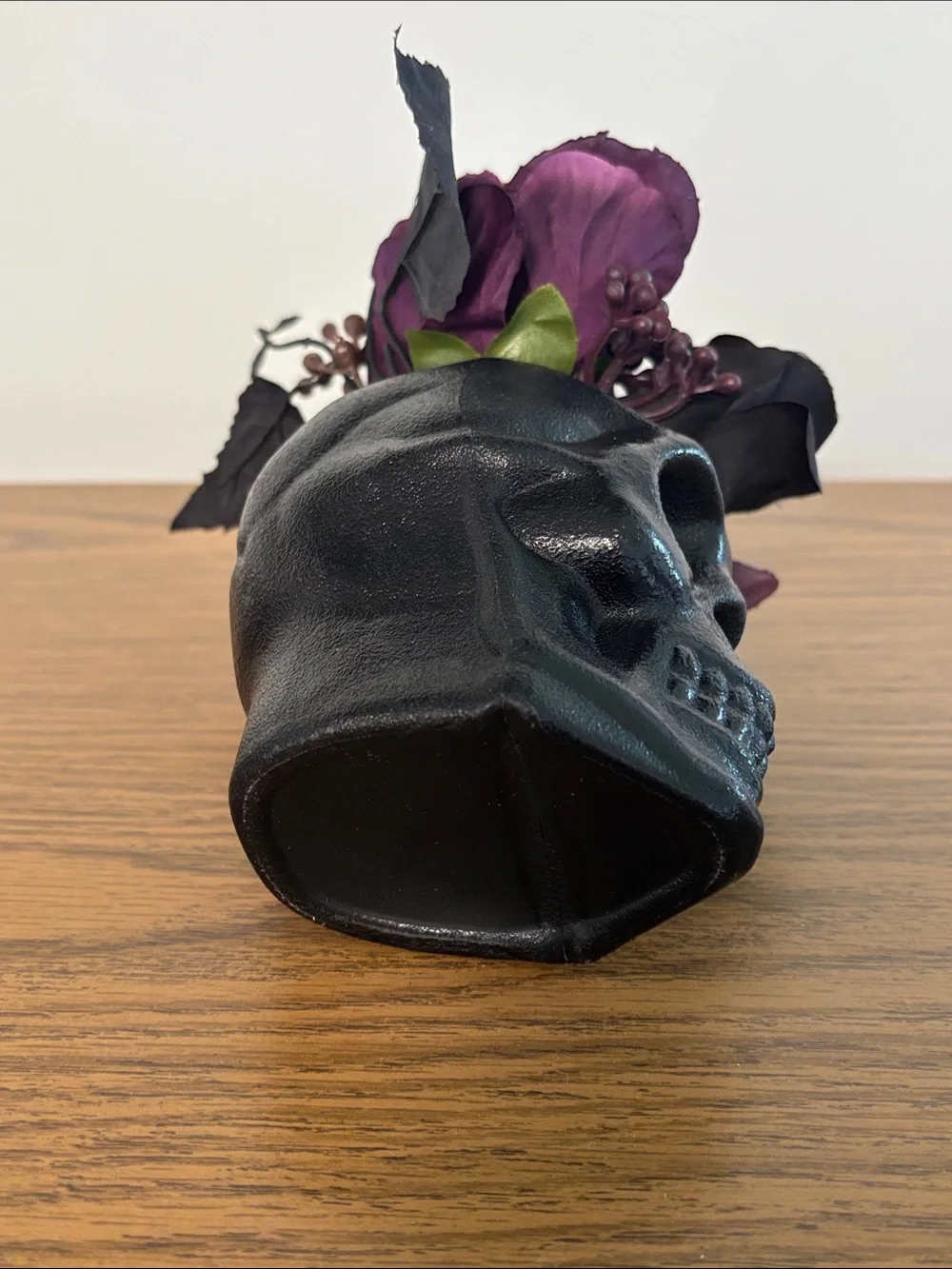 Black Skull Vase with Dark Purple Floral Arrangement